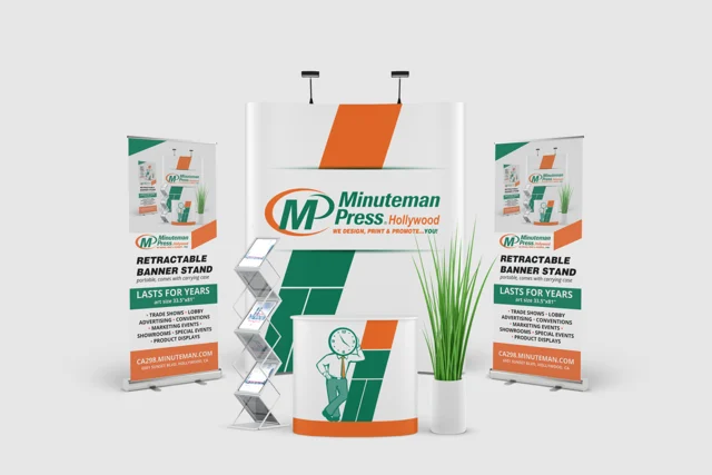 Minuteman Press Hollywood exhibition display with orange and green backdrop, roll-up banners and counter